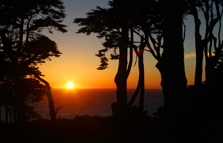The sun sets over the Pacific off Land's End, San Francisco, California (9/24/2010). Photo by Bill Hubick.